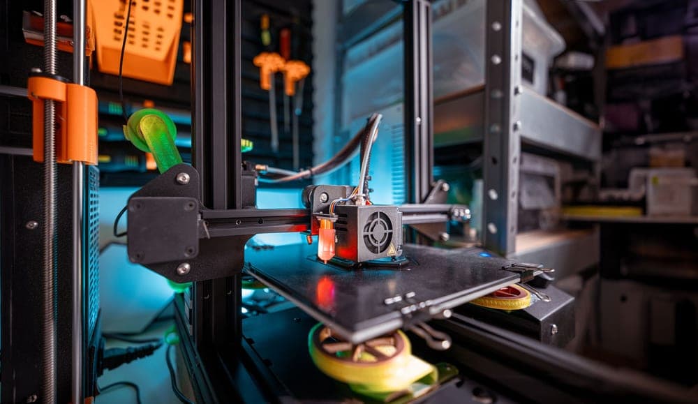 An open-frame desktop filament 3D printer part-way through a print - a stand-in for the Bambu Lab A1 mini, not a photograph of this model